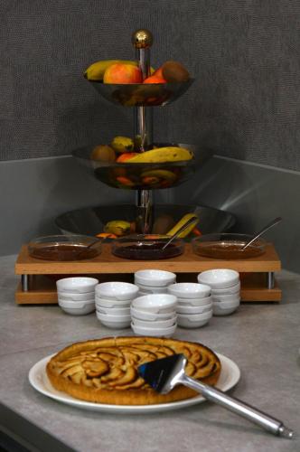 a table with a plate of food on a counter at LOGIS Hôtel de Bourgogne - Mâcon in Mâcon
