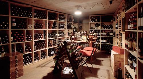 a room filled with lots of bottles of wine at Hotel Aida in Alassio