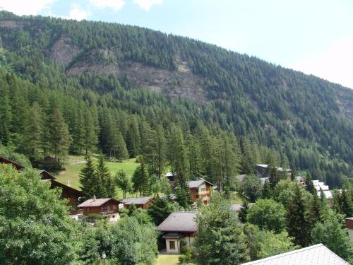 a small town in the middle of a mountain at Apartments Haus Quelle in Leukerbad