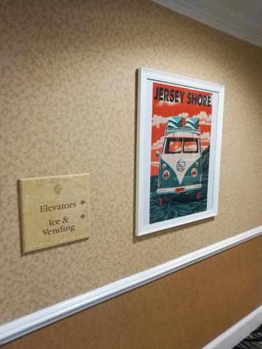 a poster of a van on a wall with a sign at The Wilshire Grand Hotel in West Orange