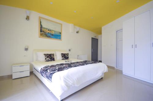 a bedroom with a large white bed in a room at Hotel Oaza in Budva