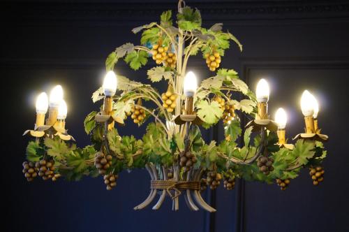 a chandelier with grapes and fruit on it at LOGIS Hôtel de Bourgogne - Mâcon in Mâcon