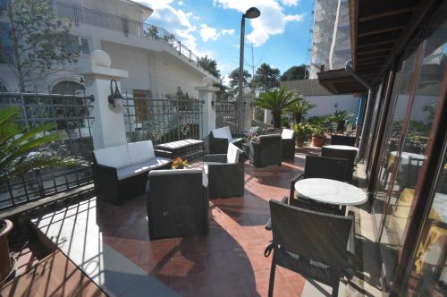 an outdoor patio with tables and chairs on a balcony at Hotel Oaza in Budva