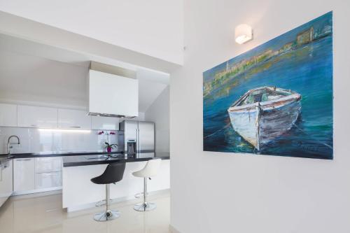 a kitchen with a painting of a boat on the wall at Villa Ivan Stanici in Omiš