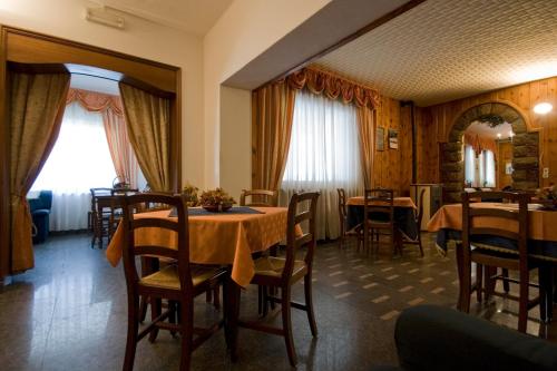 een eetkamer met een tafel en stoelen bij Hotel Napoleon in Montjovet