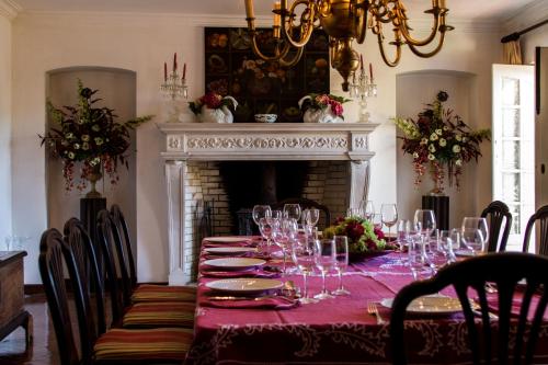 a dining room with a table with wine glasses at Quinta de São Lourenço in São Lourenço do Bairro