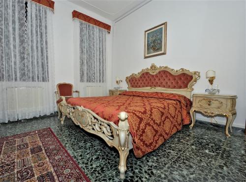 a bedroom with a bed with a red bedspread at Venice San Leonardo in Venice