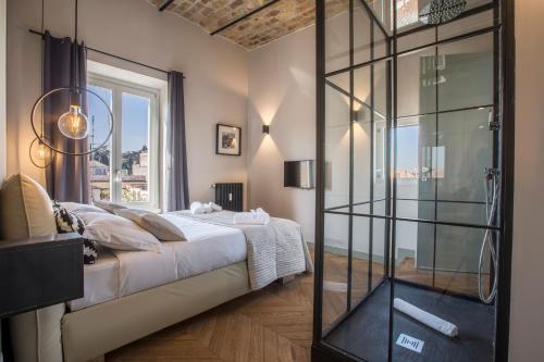 
a room with a bed and a window at EVE Penthouse Colosseo in Rome
