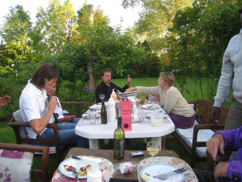 a group of people sitting around a table eating at Naboløs Rooms, near Munkebo, Kerteminde and Nyborg in Bovense