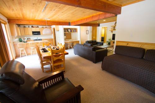 a living room with a couch and a table at Sitzmark Sports Lodge in Red River