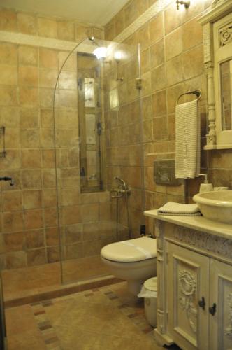 a bathroom with a shower and a toilet and a sink at Ziyabey Konagi in Ayvalık