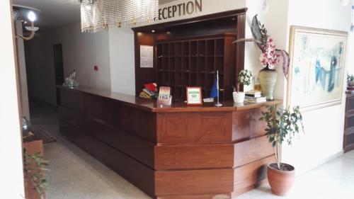 a reception desk in a store with plants at Filippos in Nea Moudania