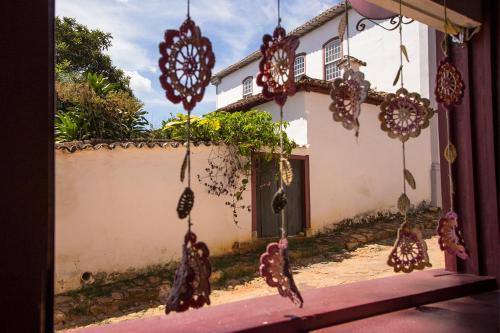 a house with lots of decorations hanging from it at Pousada Do Ó in Tiradentes