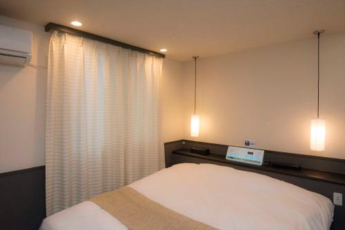 Ένα ή περισσότερα κρεβάτια σε δωμάτιο στο Hotel Double Funabashi