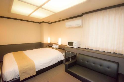 Ένα ή περισσότερα κρεβάτια σε δωμάτιο στο Hotel Double Funabashi