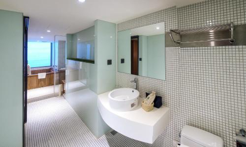 a bathroom with a white sink and a mirror at Energy Inn in Taipei