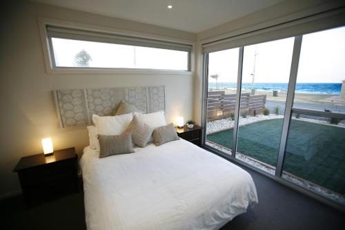 Un pat sau paturi într-o cameră la Aloha Beachfront Port Fairy