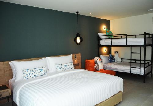 a bedroom with a bed and two bunk beds at Fusion Suites Phuket Patong in Patong Beach