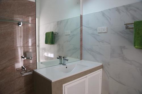 a bathroom with a sink and a mirror at Hikka Nature Villa in Hikkaduwa