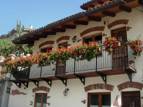 a building with flower boxes on the balconies at Le Village in Montjovet