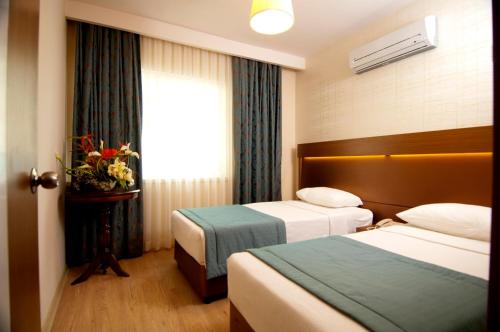 Ένα ή περισσότερα κρεβάτια σε δωμάτιο στο Supreme Hotel