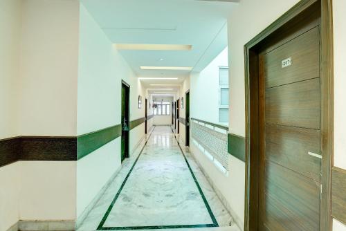 a hallway with a glass floor in a building at Treebo C T International in New Delhi