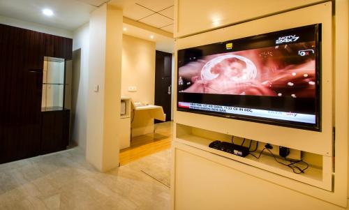 a room with a large television with a picture of a tumor at Art Boutique Hotel Gachibowli in Hyderabad