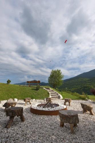 a kite flying in the sky over a fire pit at Apartments Pri nas in Kobarid