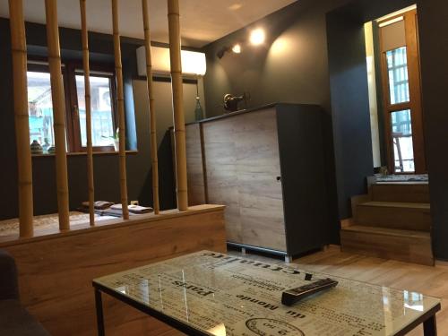 a living room with a glass table and stairs at City Garden Studio in Plovdiv