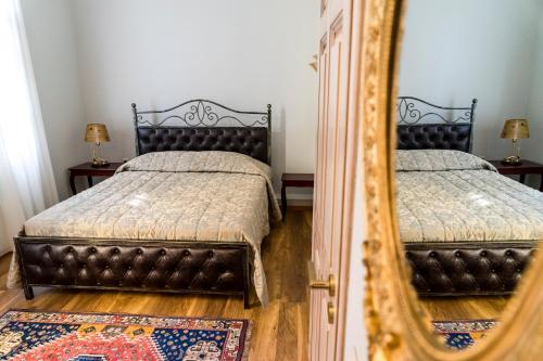 a bedroom with two beds and a mirror at Le Bijou Luxury Rooms & Suites in Veria