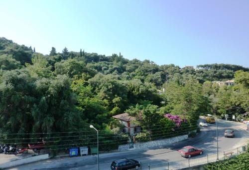 a road with cars parked on the side of a hill at Hotel Perama in Perama