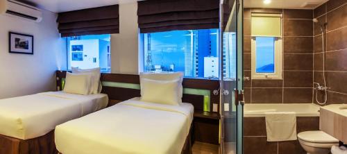 Aroma Nha Trang Boutique Hotel tesisinde bir odada yatak veya yataklar