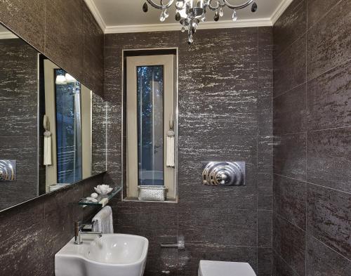 a bathroom with a sink and a mirror at Villa EverGreen in Heraklio Town