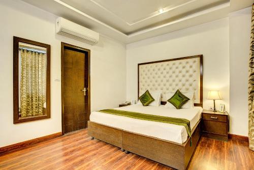 a bedroom with a large bed in a room at Treebo C T International in New Delhi