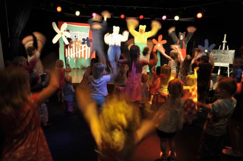 a group of children dancing in front of a stage at Barut B Suites in Side
