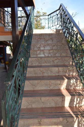 a set of stairs with a metal railing at "STELIOS & GALINI" in Symi