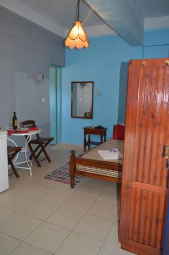 a living room with a bed and a table and a table at "STELIOS & GALINI" in Symi