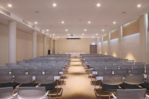 an empty lecture hall with rows of chairs and a podium at Droushia Heights Hotel in Droushia