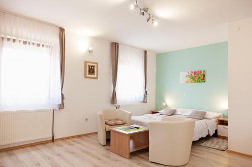 a living room with a bed and a couch at Guest House Ljubica in Rastovača