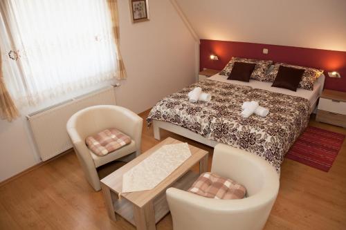 a bedroom with a bed and a table and chairs at Guest House Ljubica in Rastovača