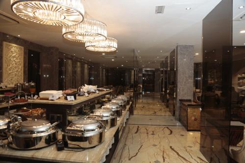 a restaurant with a row of pots and pans at Moty Hotel in Melaka