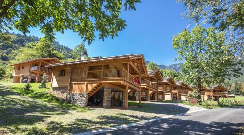 a large log cabin with a road in front of it at Ledro Mountain Chalet in Ledro