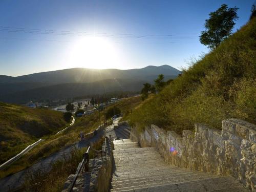 a set of stairs on a hill with the sun shining at EretZefat in Safed