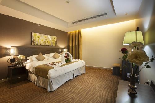 a hotel room with a large bed in a room at Hayat Watheer for serviced Apartment in Dammam