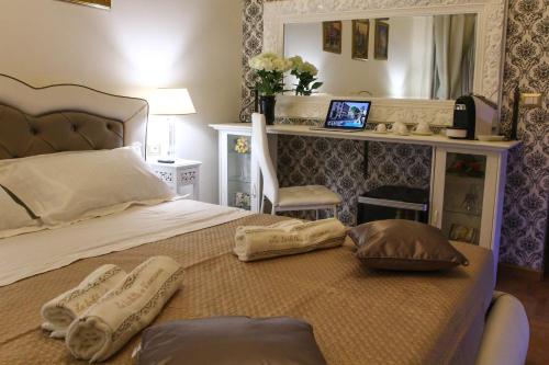 a bedroom with a bed with two pillows and a mirror at Barberini Dream in Rome