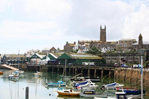 a group of boats are docked in a harbor at The Dock Inn in Penzance