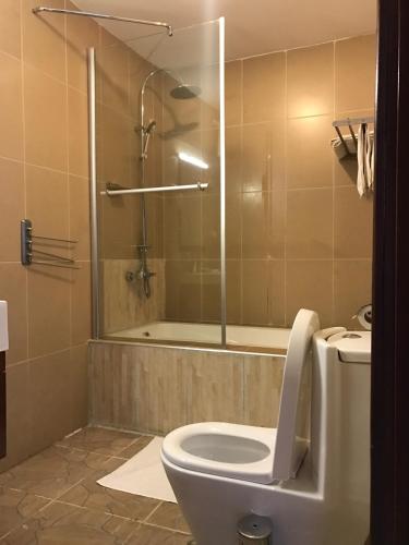 a bathroom with a toilet and a shower at Inside Afrika Boutique Hotel in Kigali