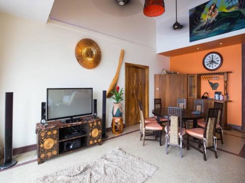 a living room with a television and a table and chairs at 5 Bedroom Seafront Villa Phangan SDV231-By Samui Dream Villas in Srithanu