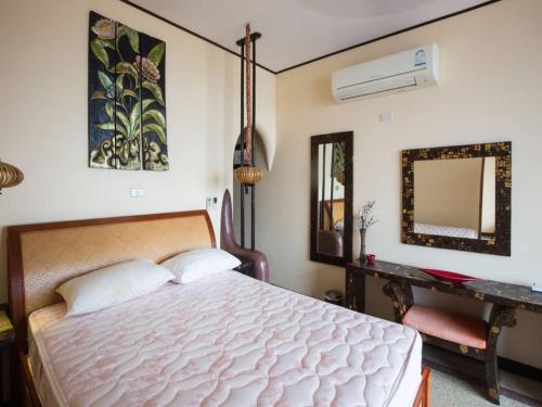 a bedroom with a white bed and a mirror at 5 Bedroom Seafront Villa Phangan SDV231-By Samui Dream Villas in Srithanu