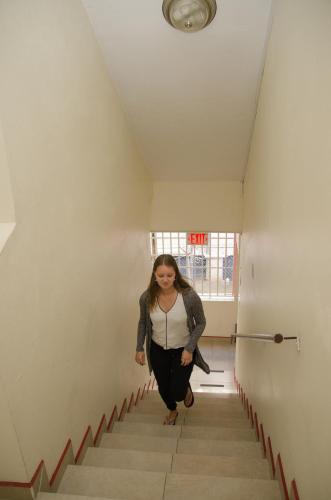 a woman walking down a stairs in a hallway at Alicia's Inn in Philipsburg